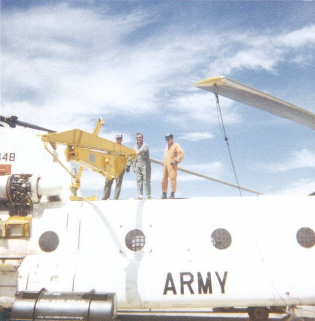 Chinook helicopter 60-03448 and the airframe mounted lifting crane designed to aid in the removal and replacement of large, heavy components such as the engines and rotor blades, circa 1964. 